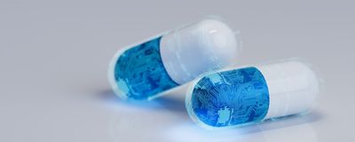 Conceptional image of two pills covered with a circuit-board pattern.