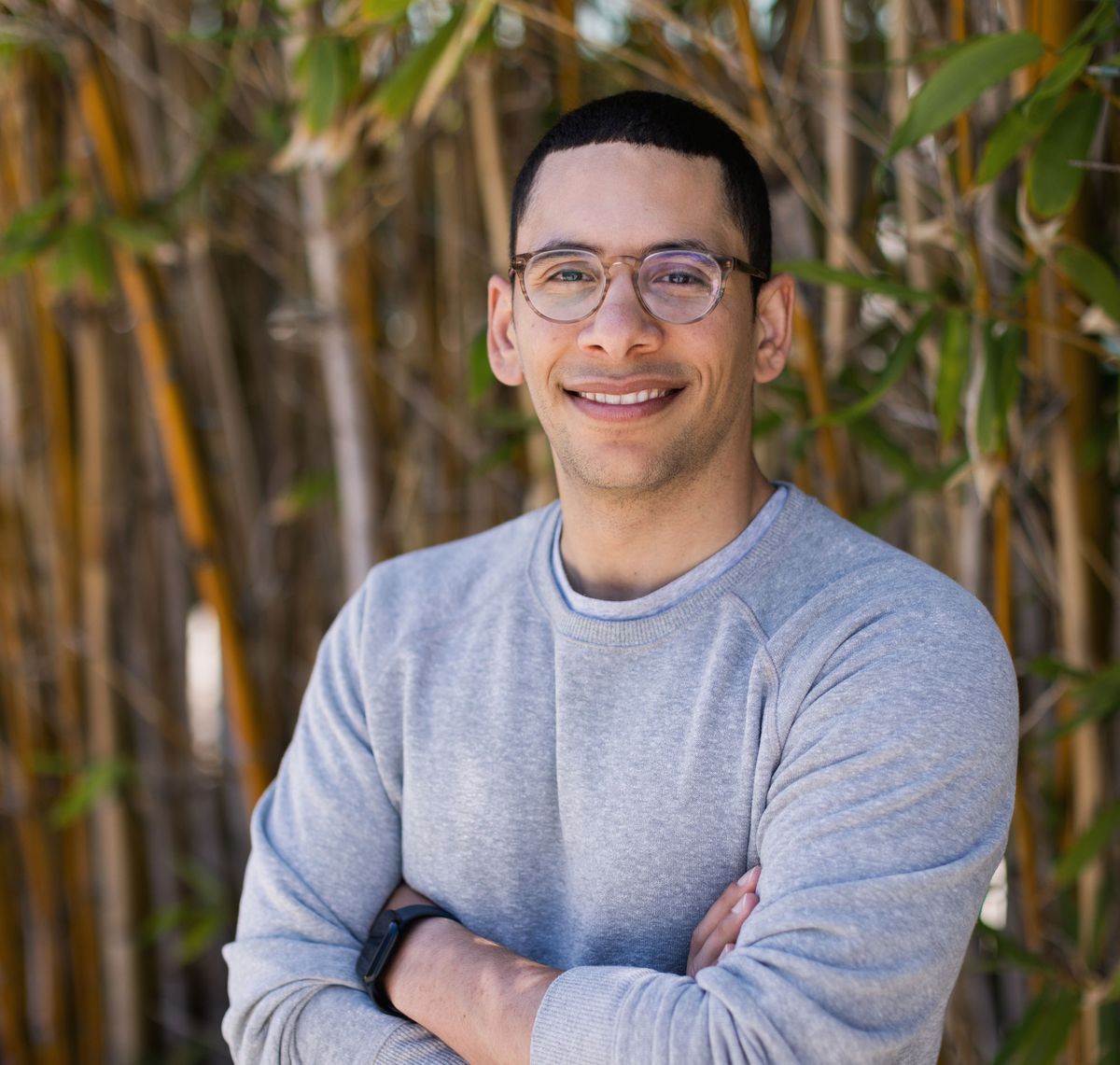 Ahmed Badran wears a grey sweater and smiles at the camera with his arms crossed. Ahmed Badran wears a grey sweater and smiles at the camera with his arms crossed.