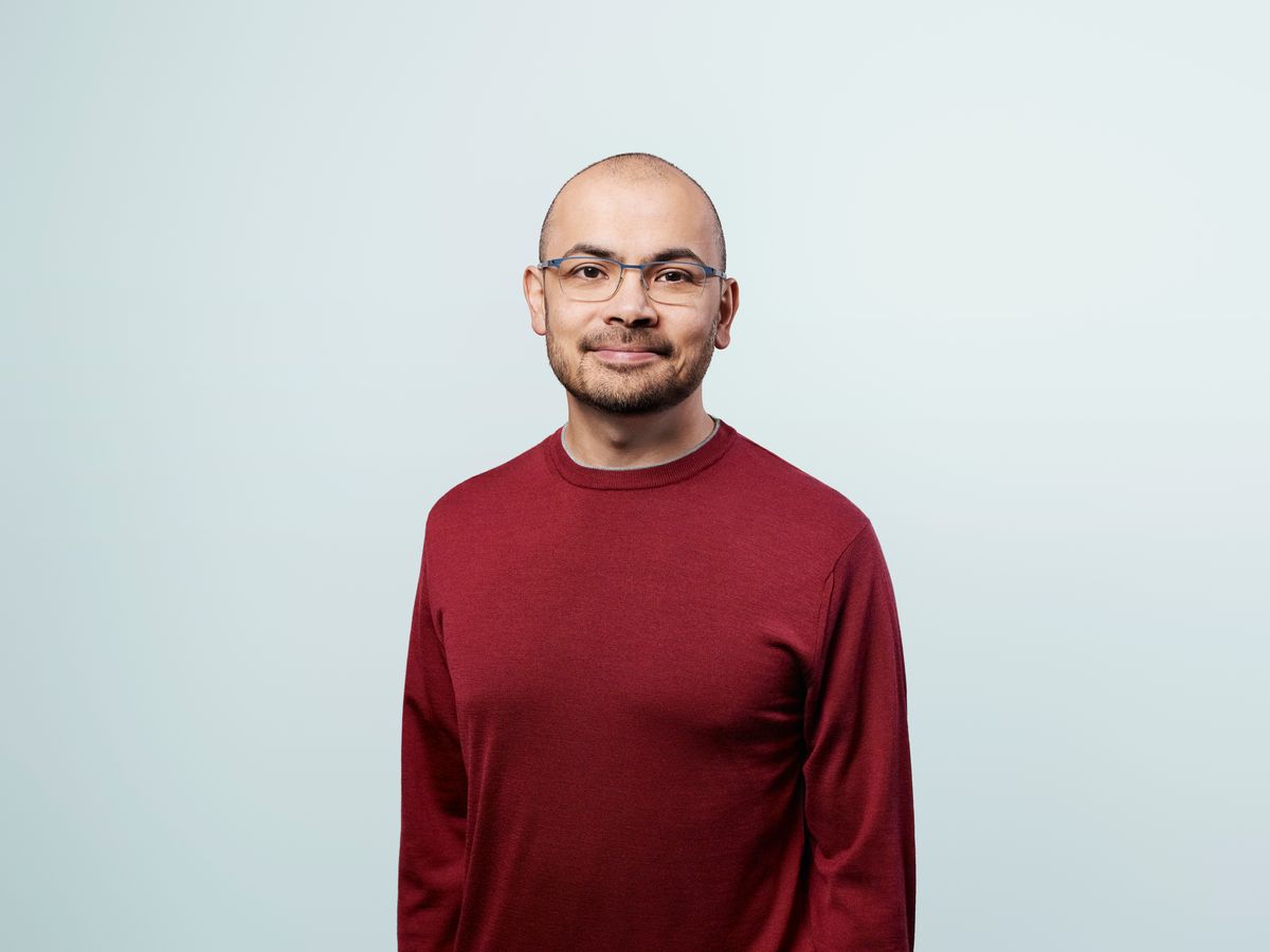 Headshot of Demis Hassabis. He wears glasses and a red sweater. Headshot of Demis Hassabis. He wears glasses and a red sweater.