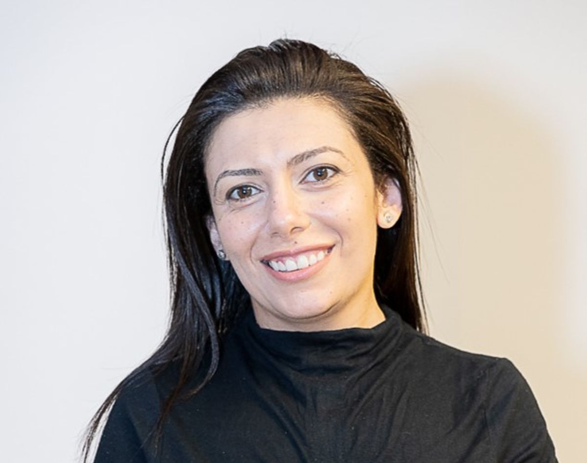 A black-haired woman poses dressed in black A black-haired woman poses dressed in black