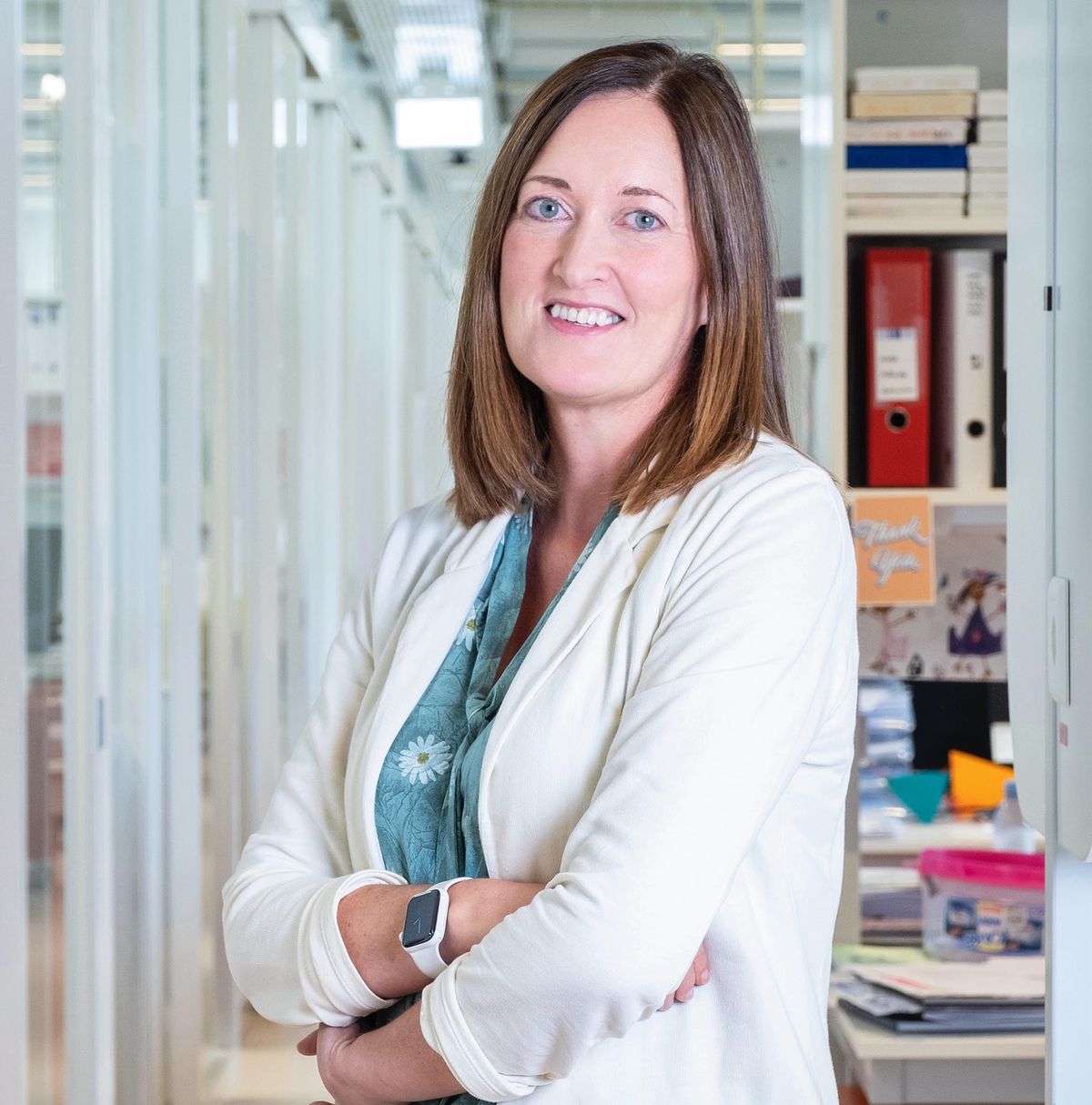 Johanna Joyce has shoulder-length brown hair and is wearing a white blazer over a blue shirt. Johanna Joyce has shoulder-length brown hair and is wearing a white blazer over a blue shirt.