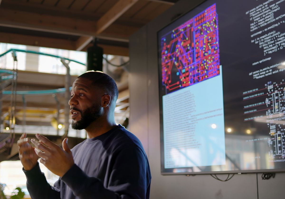 An individual standing in front of a screen, delivering a lesson. An individual standing in front of a screen, delivering a lesson.