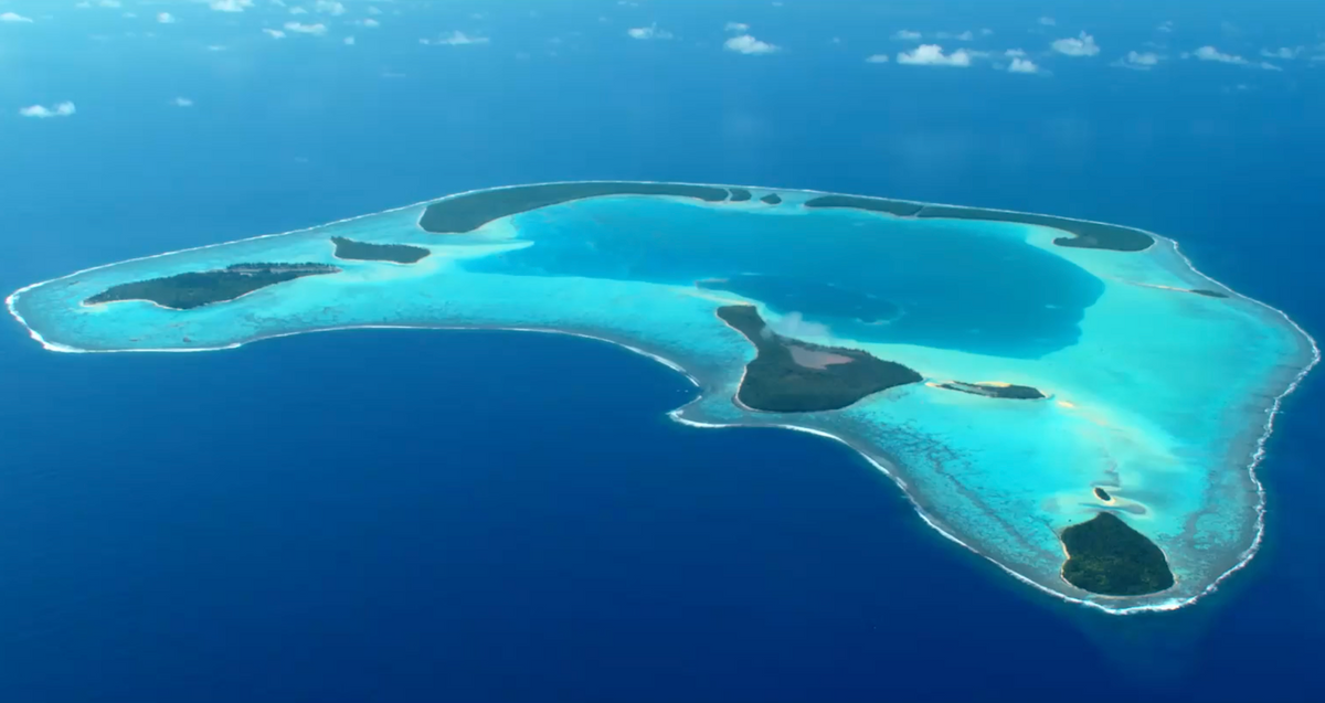 Aerial view of an atoll and the surrounding water Aerial view of an atoll and the surrounding water